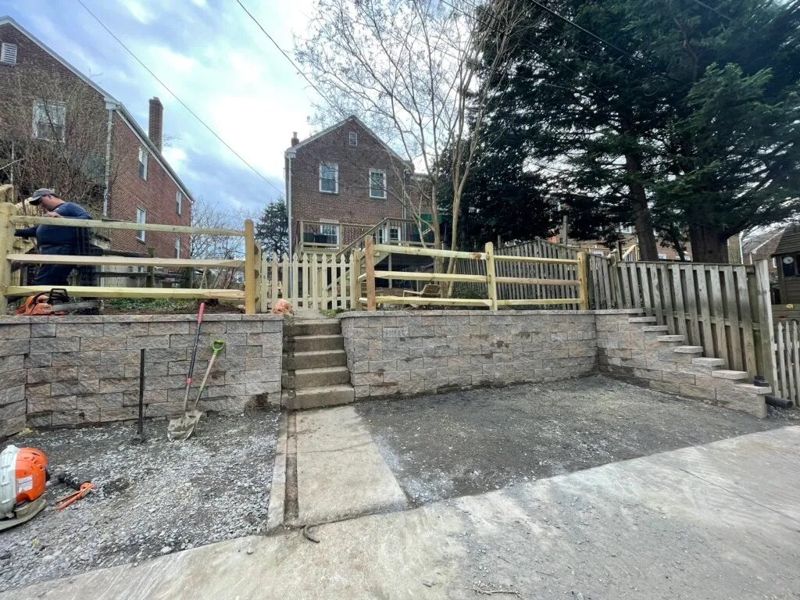 Two-tier block wall with built-in steps and fencing